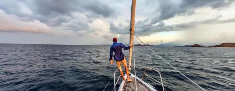 Man sailing a boat at sea